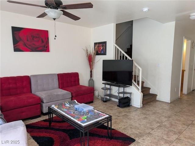 tiled living room featuring ceiling fan, stairs, and baseboards