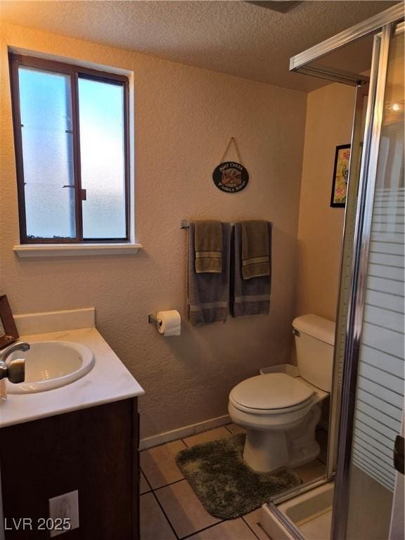 bathroom with toilet, tile patterned floors, a textured ceiling, vanity, and a shower stall