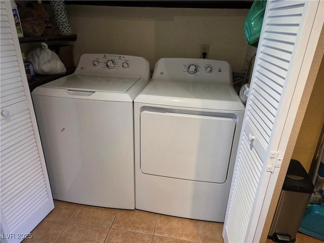 laundry room with laundry area, light tile patterned flooring, and independent washer and dryer