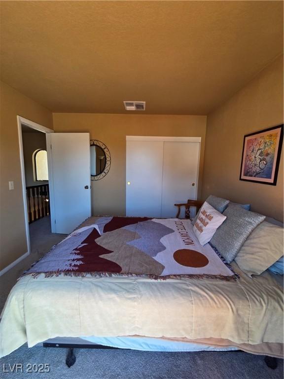 bedroom with a closet and visible vents