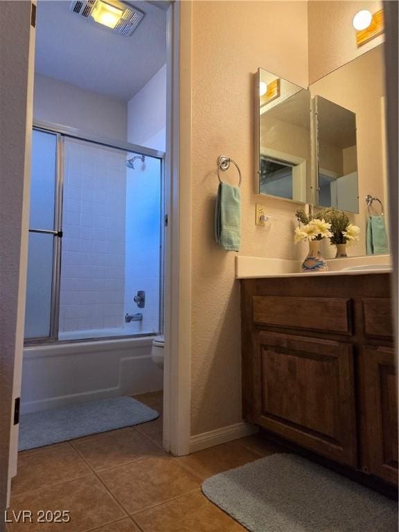 full bath with visible vents, toilet, enclosed tub / shower combo, tile patterned floors, and vanity