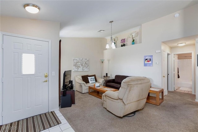 carpeted living area featuring vaulted ceiling, tile patterned flooring, visible vents, and an inviting chandelier