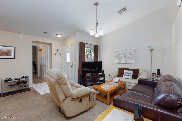 living room with vaulted ceiling, a notable chandelier, visible vents, and light colored carpet