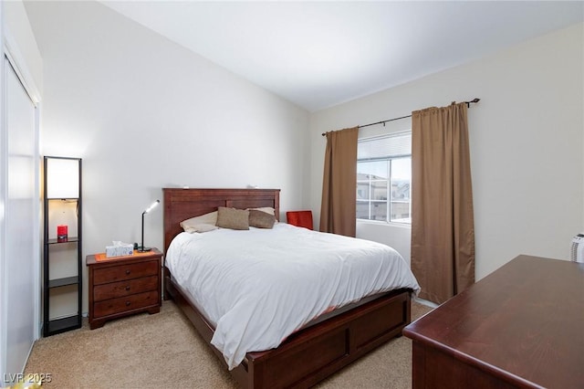 bedroom featuring light carpet and lofted ceiling