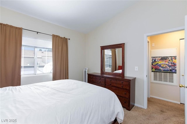 bedroom featuring baseboards, vaulted ceiling, and light colored carpet