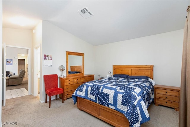 carpeted bedroom with lofted ceiling and visible vents