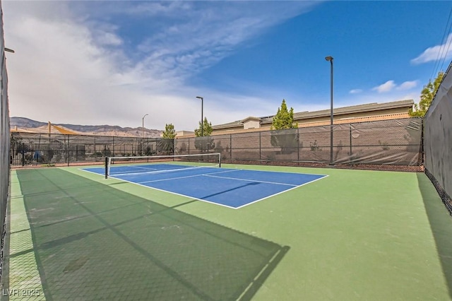 view of tennis court featuring fence