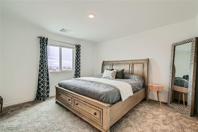 carpeted bedroom featuring visible vents and baseboards