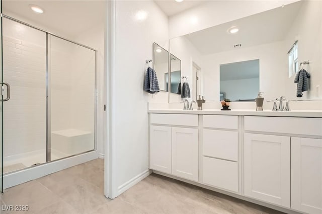 full bath with a stall shower, a sink, recessed lighting, and double vanity