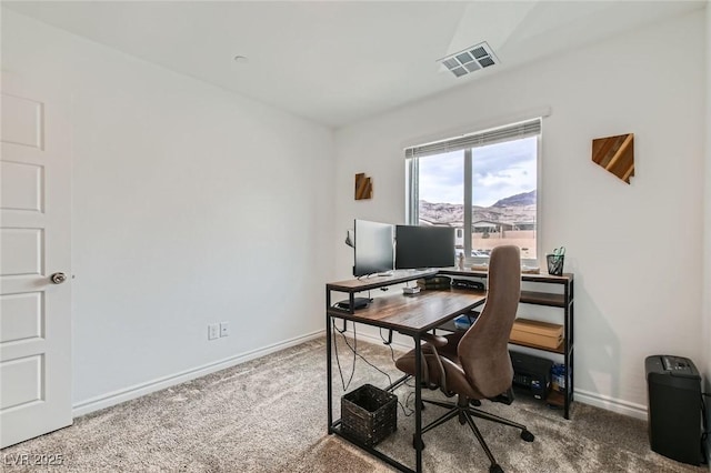 office space with carpet, visible vents, and baseboards