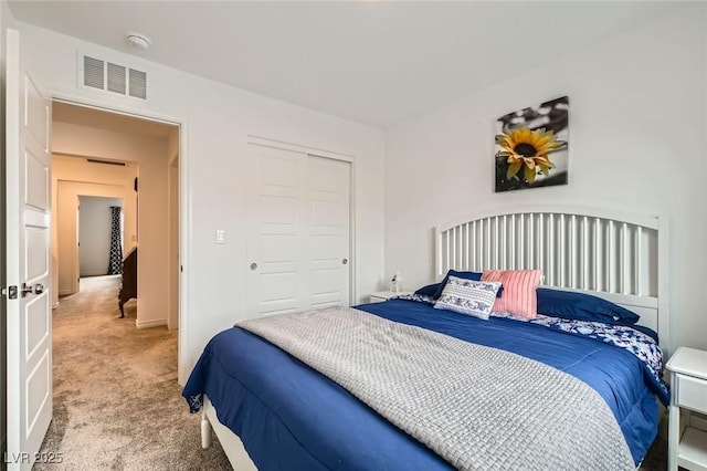 carpeted bedroom featuring a closet and visible vents