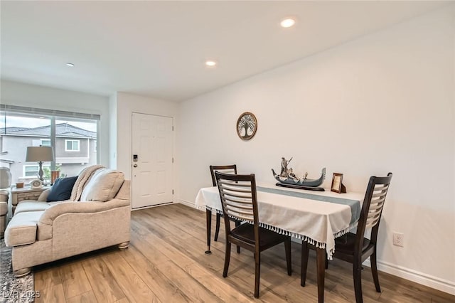 dining area featuring recessed lighting, wood finished floors, and baseboards