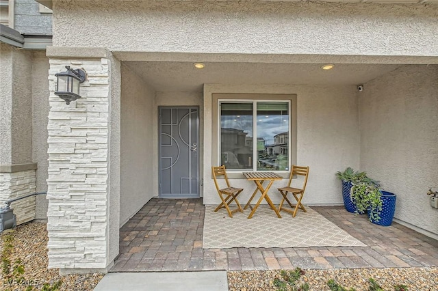 view of exterior entry featuring stucco siding