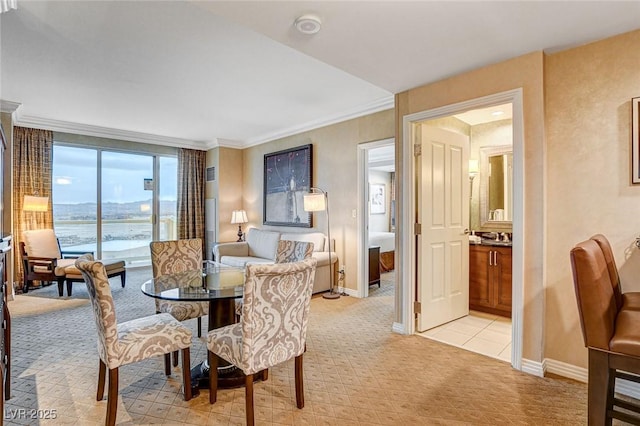 dining area with light colored carpet, baseboards, and ornamental molding