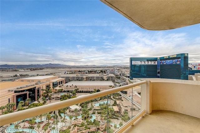 balcony with a mountain view and a view of city