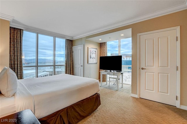 bedroom featuring floor to ceiling windows, crown molding, and baseboards