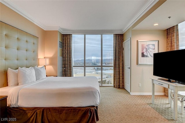 bedroom with crown molding, floor to ceiling windows, and baseboards