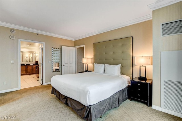 bedroom featuring ensuite bath, baseboards, and ornamental molding