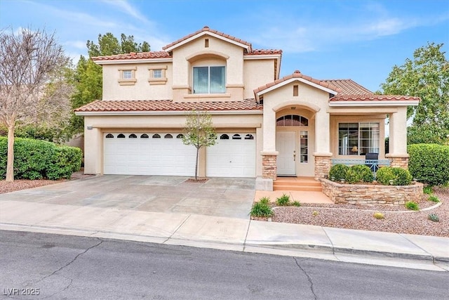 mediterranean / spanish-style home featuring a garage, concrete driveway, stone siding, and stucco siding