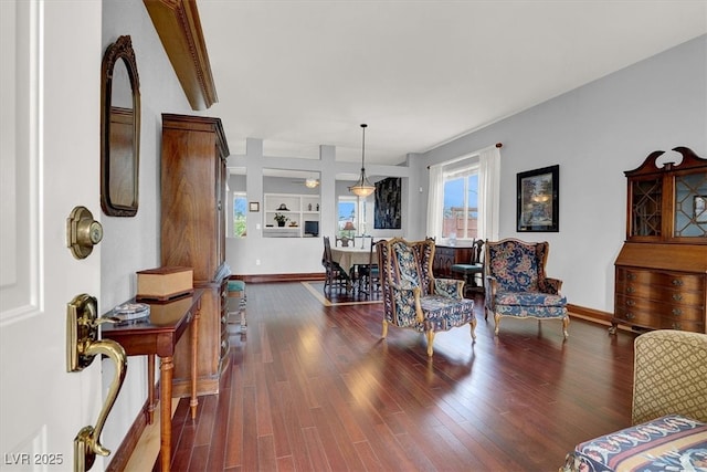 living area featuring dark wood-style floors and baseboards