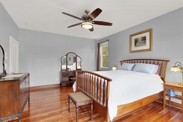 bedroom with light wood-style floors and baseboards