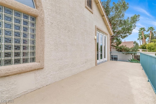 view of patio / terrace with french doors and a balcony