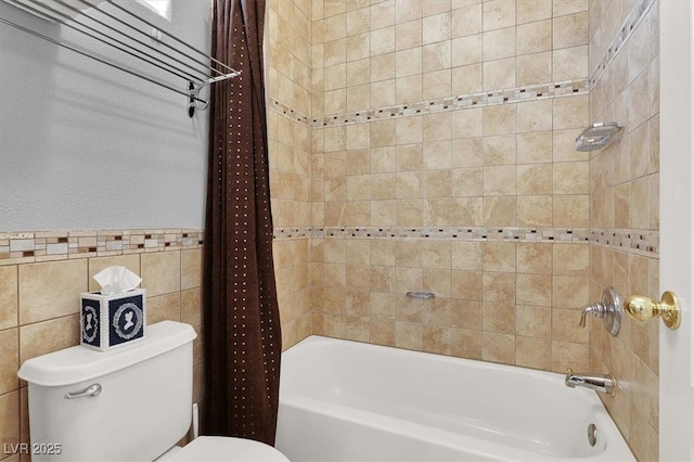 full bath with shower / bath combination with curtain, tile walls, and toilet