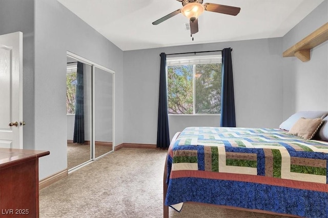 carpeted bedroom with ceiling fan, a closet, and baseboards