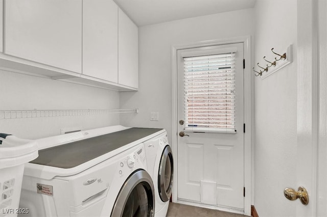 washroom featuring washing machine and dryer and cabinet space