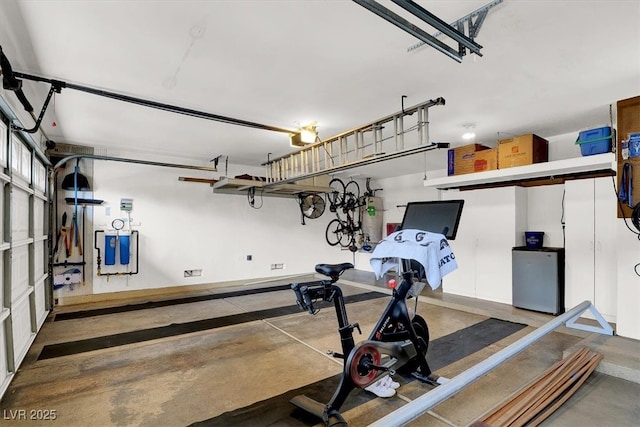 exercise area with a garage and water heater