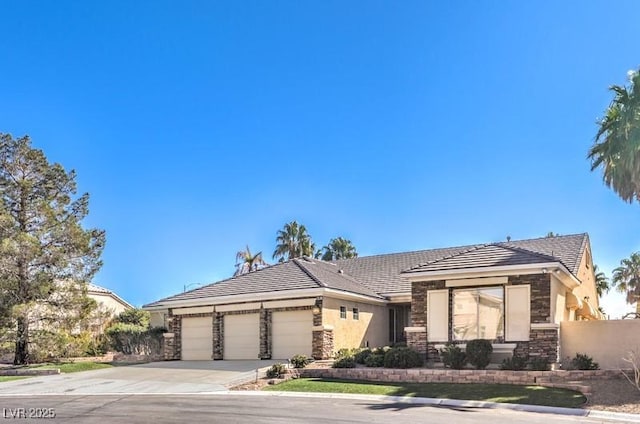 prairie-style home featuring stone siding, driveway, an attached garage, and stucco siding