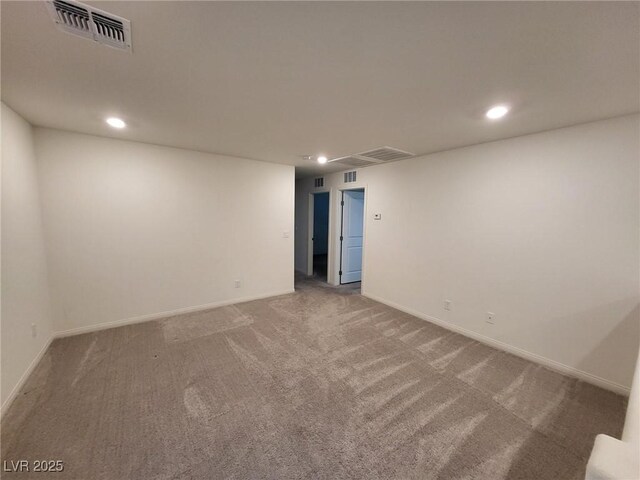 empty room featuring baseboards, visible vents, carpet flooring, and recessed lighting