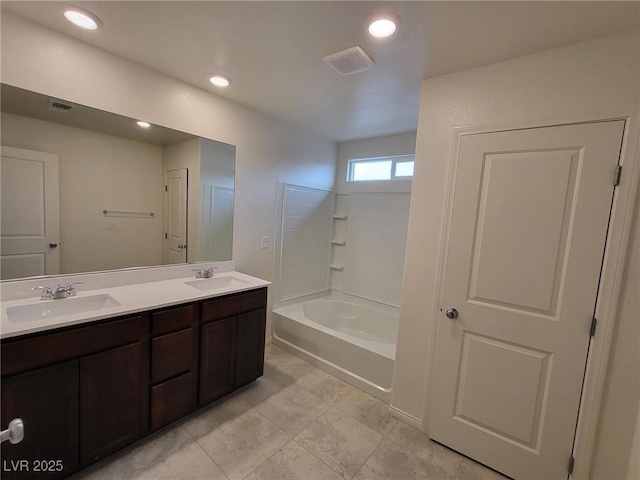 full bath with double vanity, visible vents, and a sink