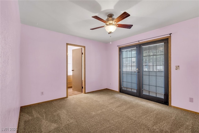 carpeted empty room featuring a ceiling fan and baseboards