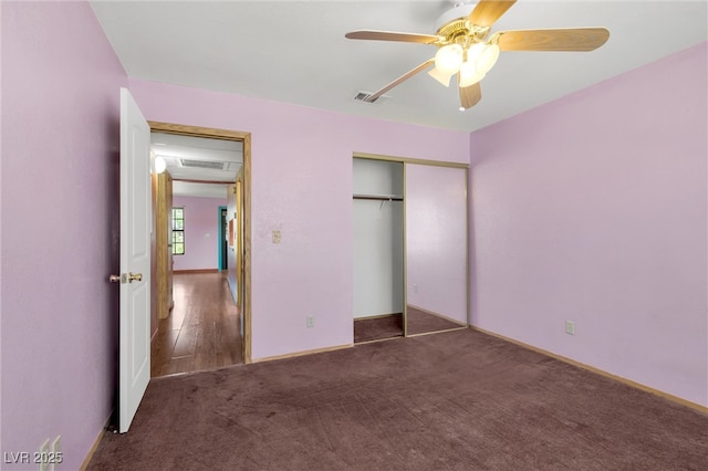 unfurnished bedroom with carpet, visible vents, a ceiling fan, and a closet