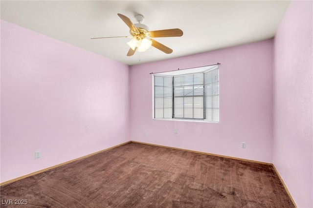 empty room featuring carpet floors, baseboards, and a ceiling fan