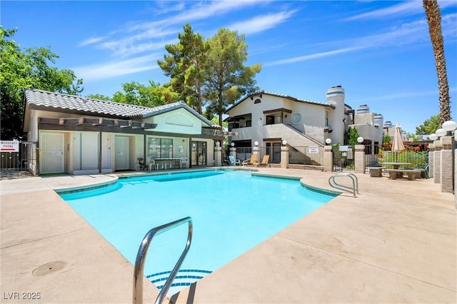 pool with fence and a patio