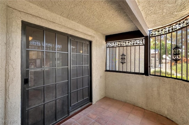 entrance to property featuring stucco siding