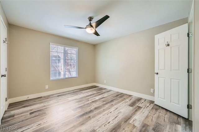 unfurnished bedroom featuring light wood-type flooring, a ceiling fan, and baseboards