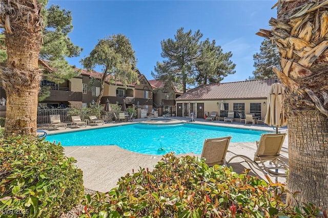 pool featuring a patio area and fence