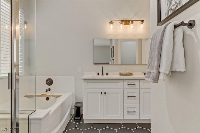 bathroom featuring a garden tub, a sink, tile patterned floors, double vanity, and an enclosed shower