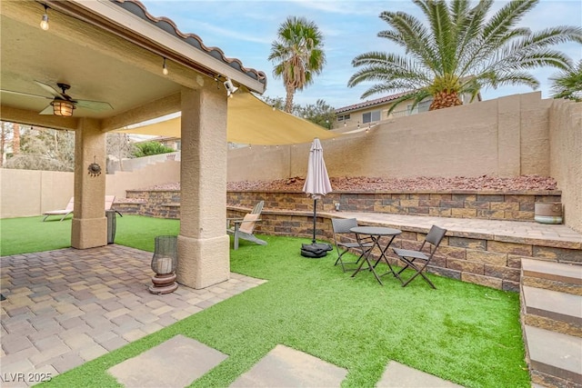 view of patio / terrace featuring a fenced backyard and a ceiling fan