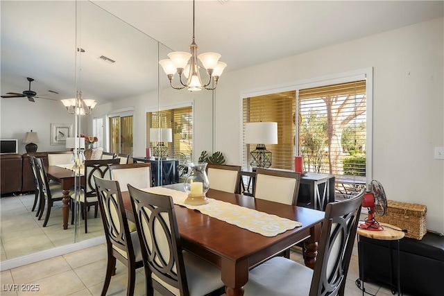 dining space with light tile patterned floors, ceiling fan with notable chandelier, visible vents, and a healthy amount of sunlight