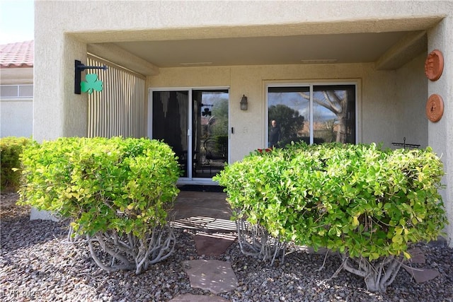 property entrance with stucco siding