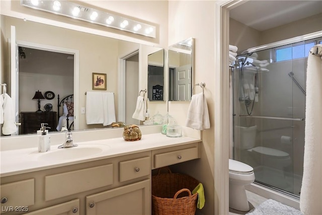 full bathroom with toilet, a stall shower, and vanity