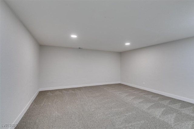 carpeted empty room featuring recessed lighting and baseboards