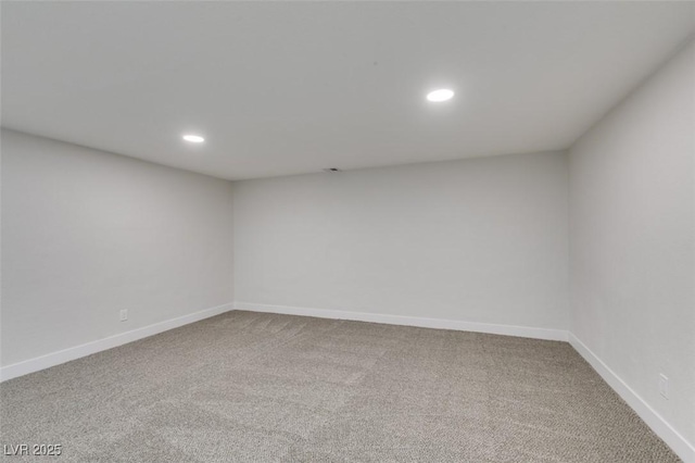 carpeted spare room featuring recessed lighting and baseboards