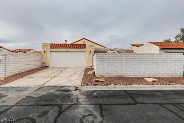 view of front of property with an attached garage, fence, concrete driveway, a tiled roof, and stucco siding