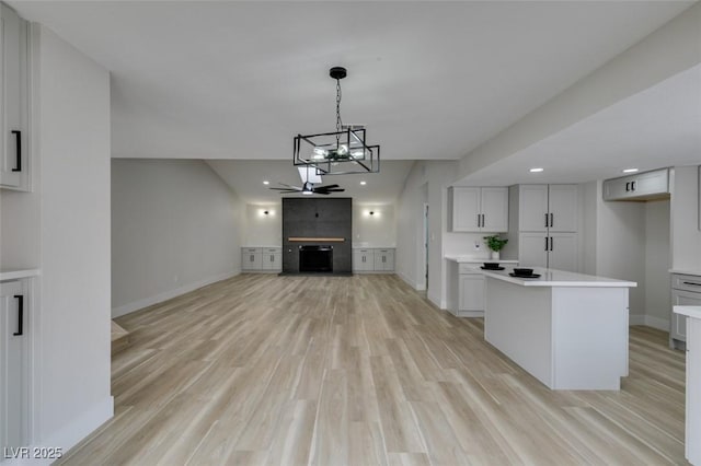 interior space featuring light wood-style flooring, baseboards, and recessed lighting