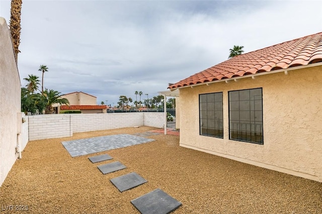 view of yard featuring a patio area and a fenced backyard